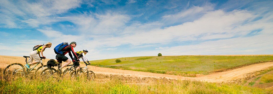 Panorama of Mountain bikers on a dirt trail